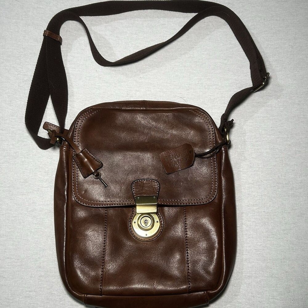 brown genuine leather crossbody bag features a lockable front flap closure